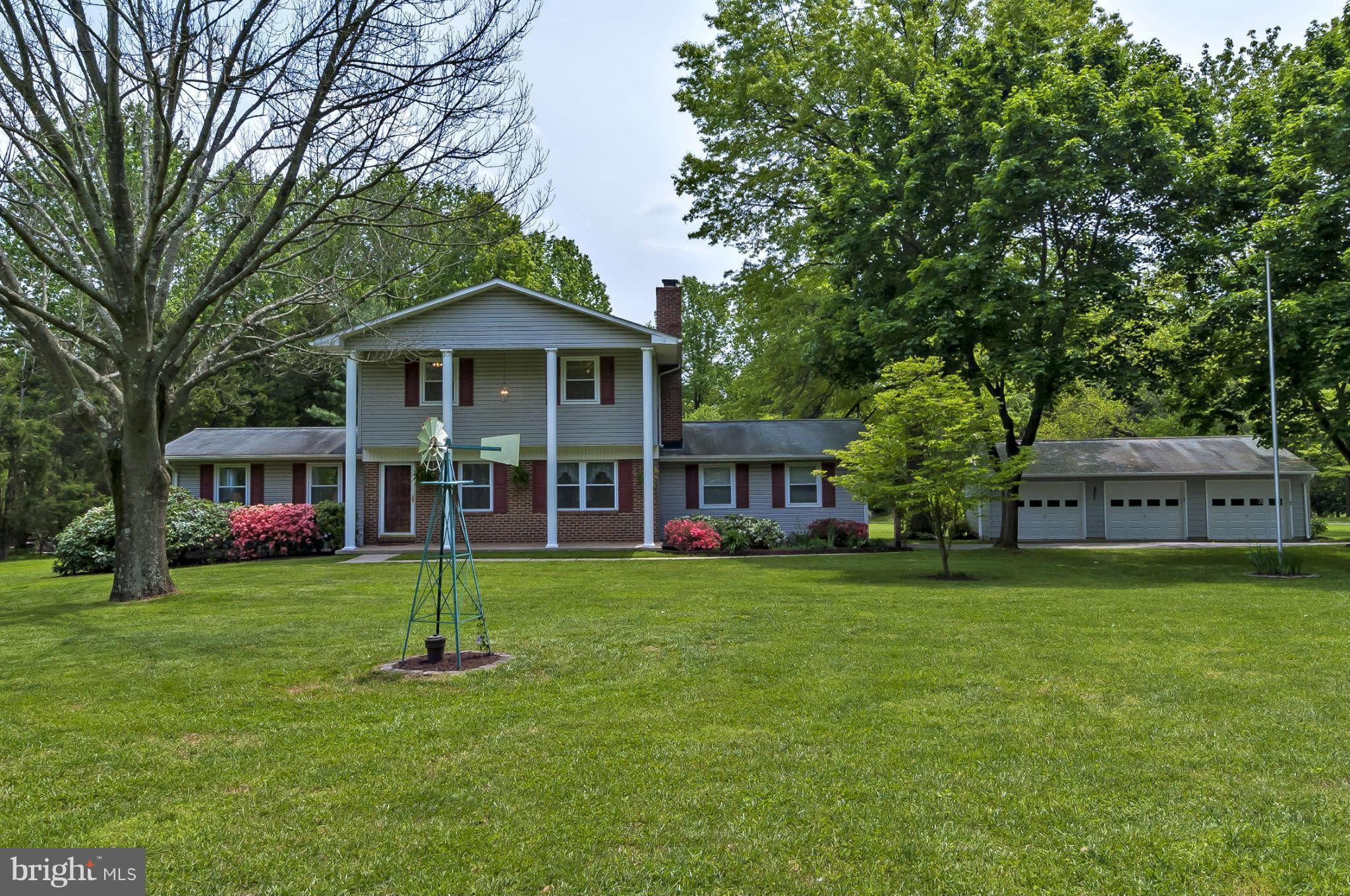 12955 Triadelphia Mill Road Clarksville, MD 21029 - Photo 3 of 29 a front view of a house with a garden