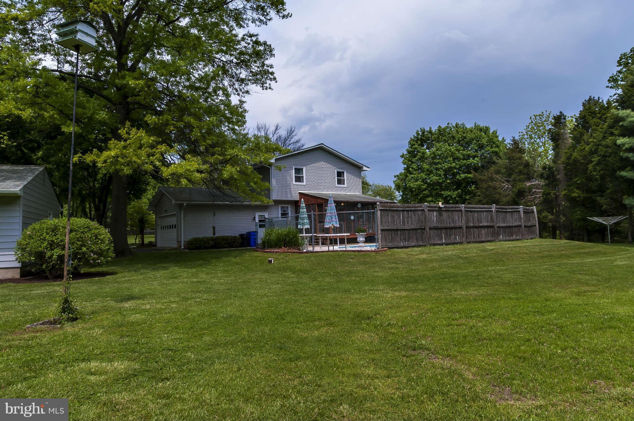12955 Triadelphia Mill Road Clarksville, MD 21029 - Photo 26 of 29 a front view of a house with a garden