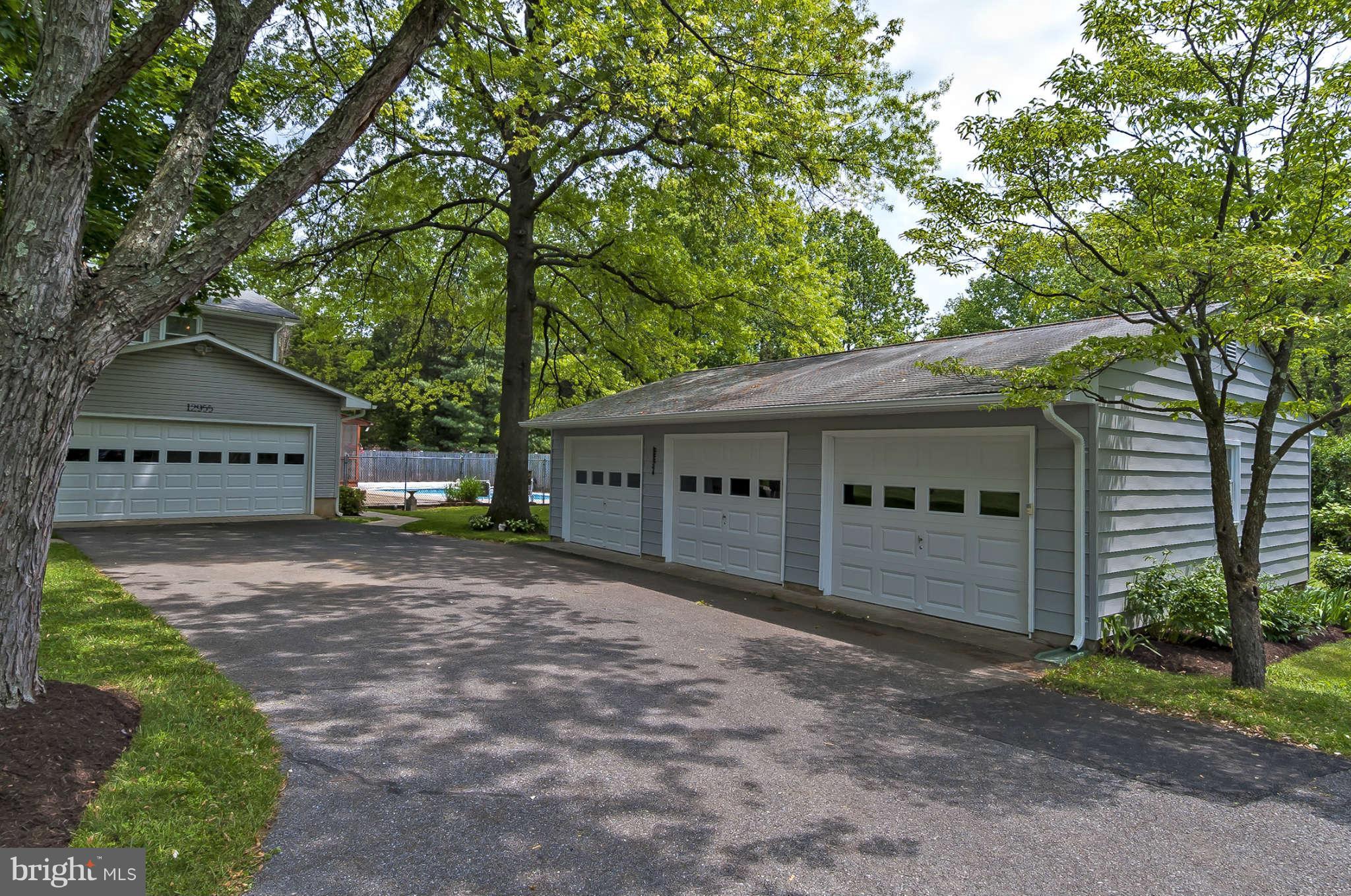 12955 Triadelphia Mill Road Clarksville, MD 21029 - Photo 5 of 29 a front view of a house with a yard and garage