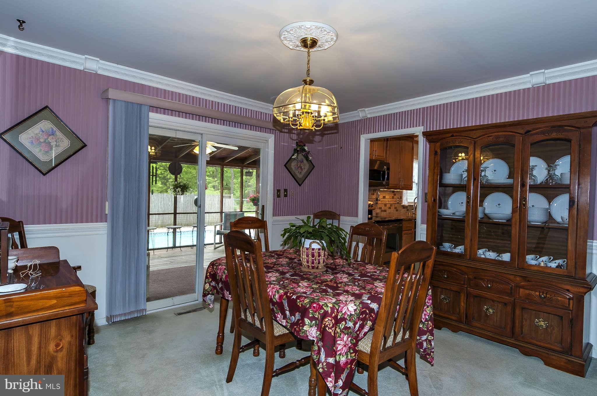 12955 Triadelphia Mill Road Clarksville, MD 21029 - Photo 8 of 29 a view of a dining room with furniture a chandelier and window