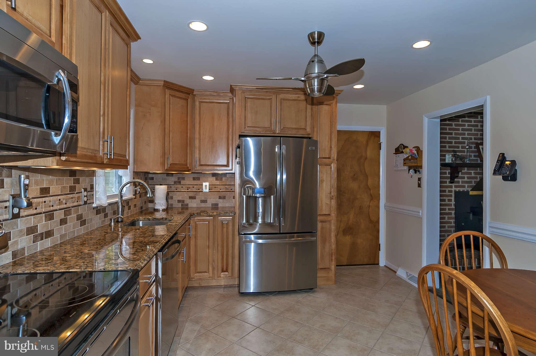 12955 Triadelphia Mill Road Clarksville, MD 21029 - Photo 9 of 29 a kitchen with stainless steel appliances granite countertop a refrigerator stove and sink