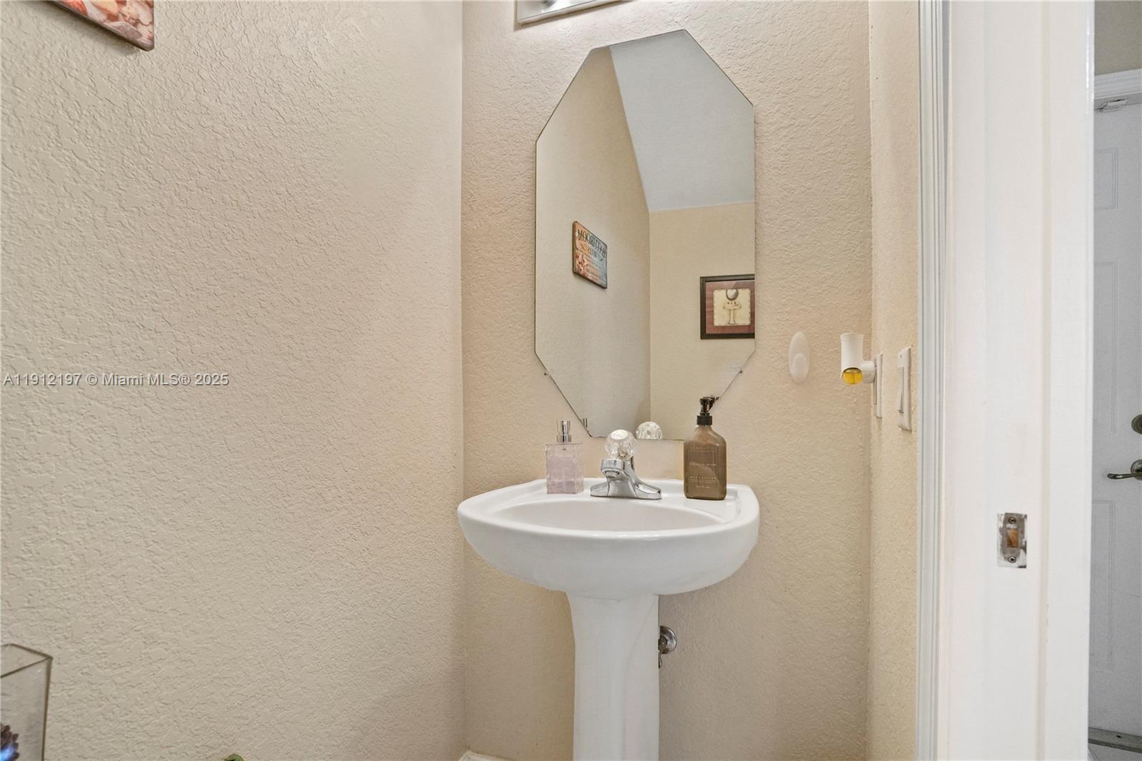 11753 Southwest 137th Path Miami, FL 33186 - Photo 17 of 33 a bathroom with a sink and a mirror