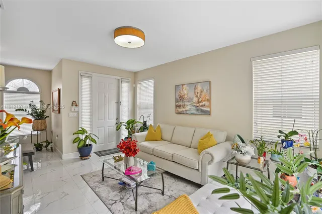 a living room with furniture and flowers