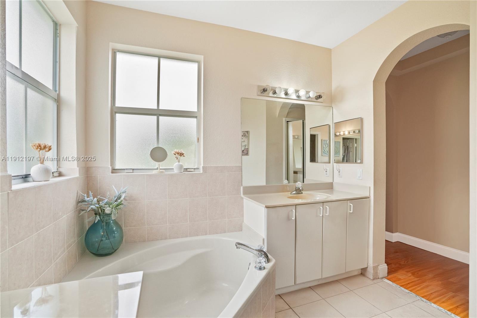 11753 Southwest 137th Path Miami, FL 33186 - Photo 7 of 33 a bathroom with a tub sink and mirror