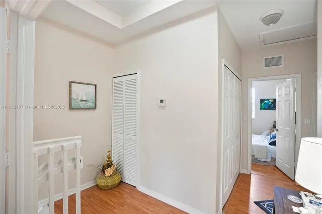 a view of a room with wooden floor and a bathroom
