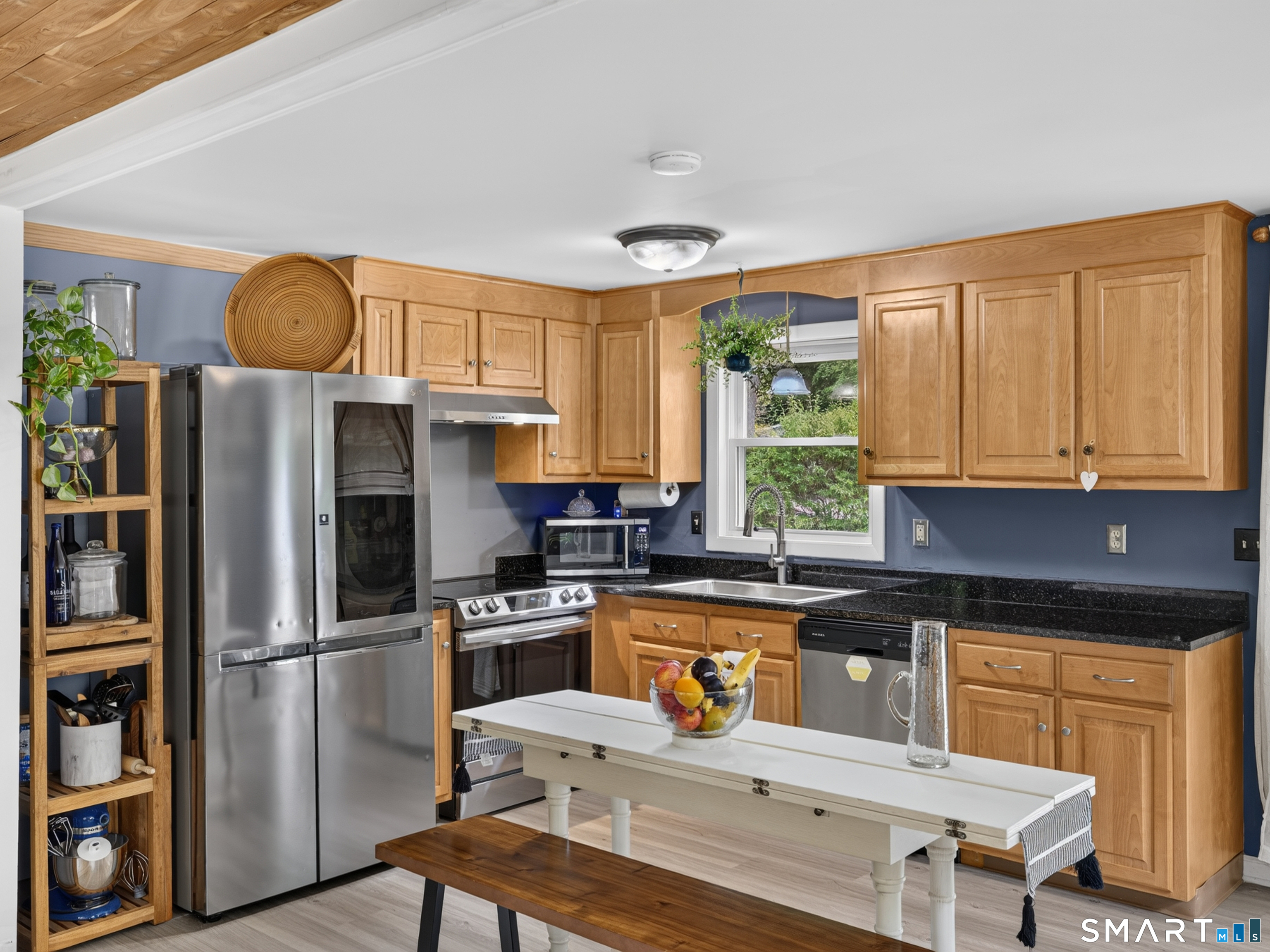 18 Old Forge Road Westbrook, CT 06498 - Photo 10 of 28 a kitchen with stainless steel appliances granite countertop a refrigerator a stove a sink dishwasher and white cabinets with wooden floor