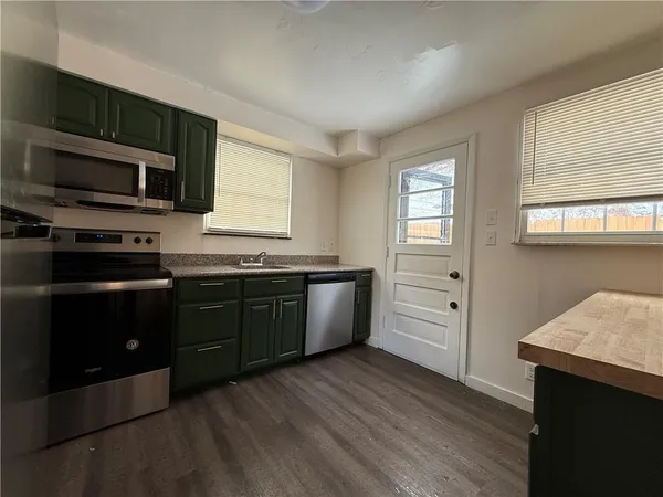 a kitchen with a sink stove and microwave