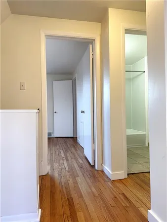 a view of a hallway with wooden floor