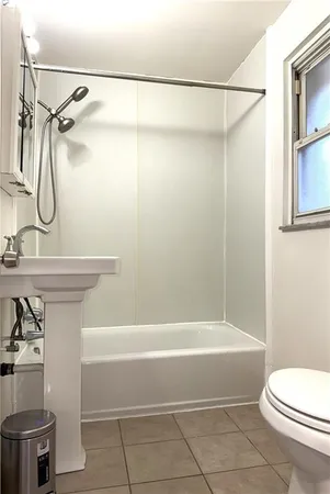 a bathroom with a shower a toilet and sink