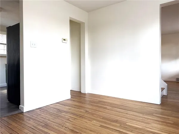 a view of a room with wooden floor
