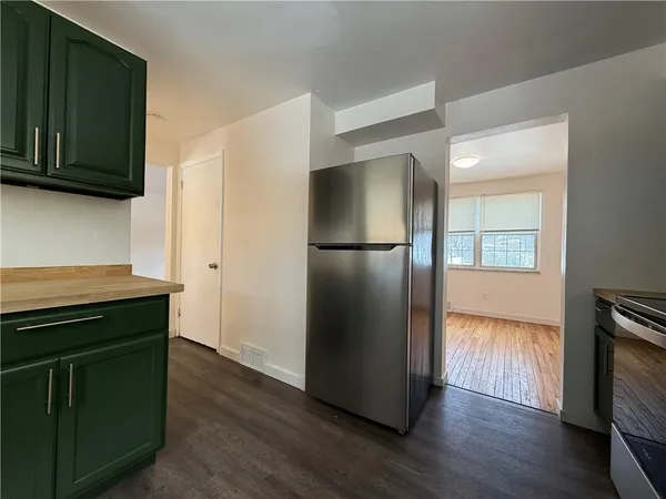 a kitchen with a refrigerator and a stove top oven
