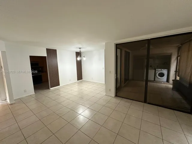 a view of a refrigerator in kitchen and entryway