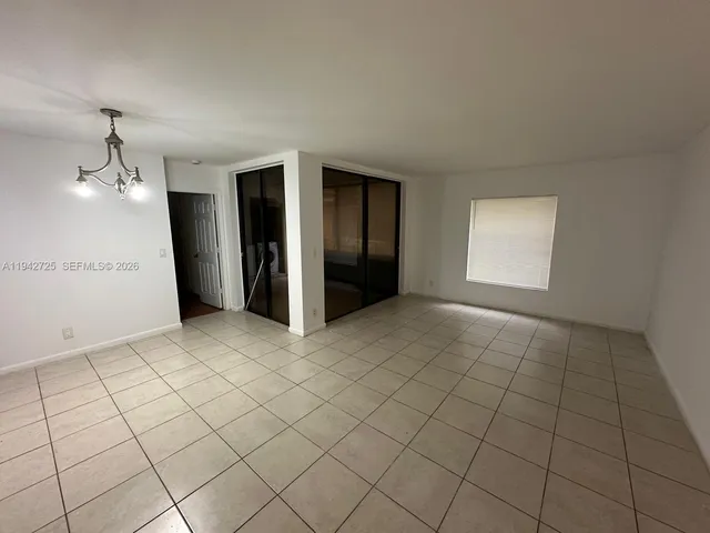 an empty room with windows and painted walls