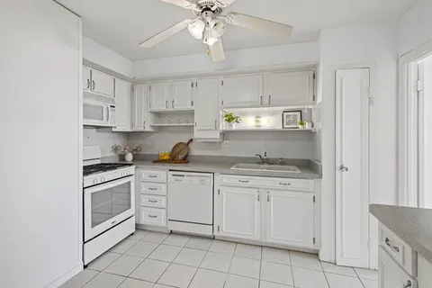 a kitchen with cabinets stainless steel appliances and a window