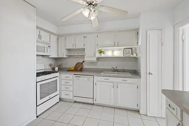 a kitchen with cabinets stainless steel appliances and a window