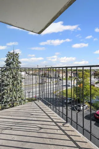 a view of balcony with wooden floor