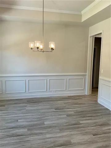 a view of wooden floor and chandelier in a room