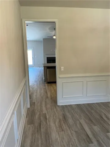 a view of hallway with wooden floor