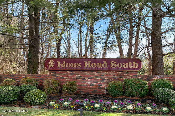 8 Carter Way Brick, NJ 08723 - Photo 20 of 27 a street sign that is sitting in a park