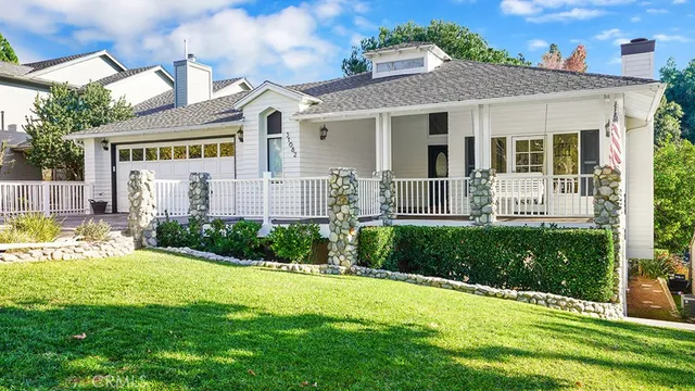 a front view of a house with garden and porch