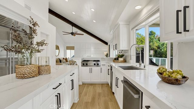 a kitchen with stainless steel appliances kitchen island granite countertop a sink and cabinets