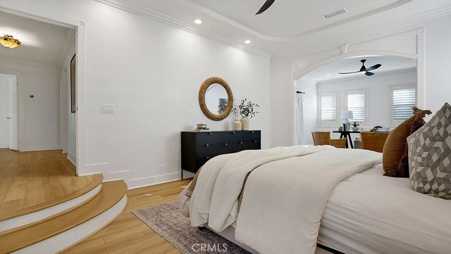 a bedroom with a bed and a chandelier