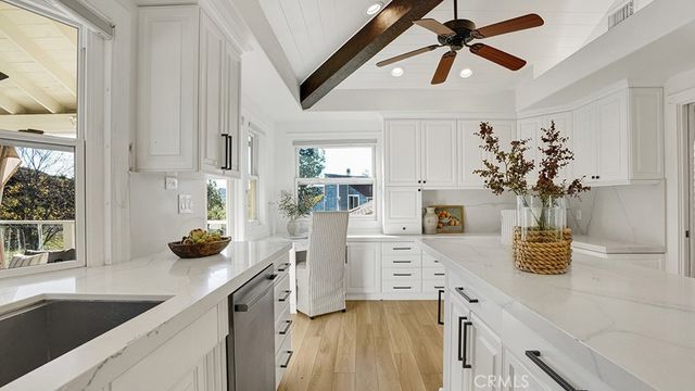 a kitchen with stainless steel appliances a sink a counter space and a window