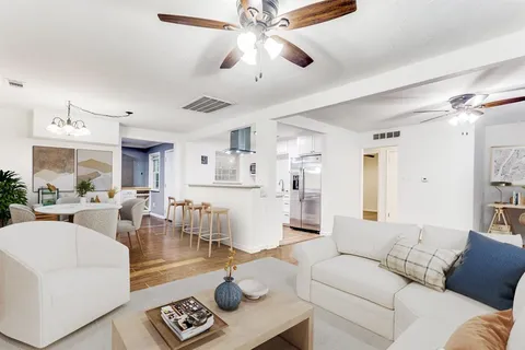a living room with furniture and a chandelier