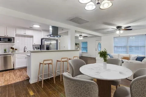 a living room with furniture a dining table and kitchen view