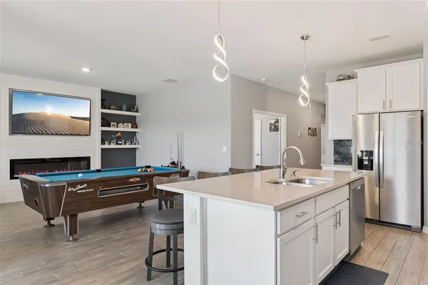 a kitchen with a sink cabinets and wooden floor