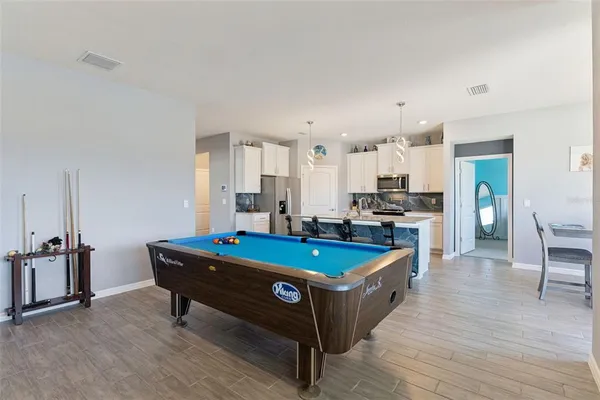 a large kitchen with a table and chairs