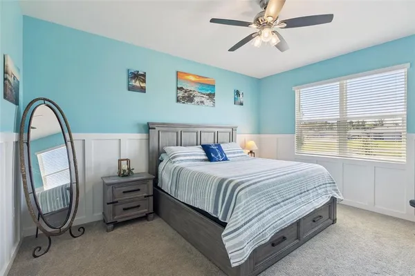 a bedroom with a bed and a mirror