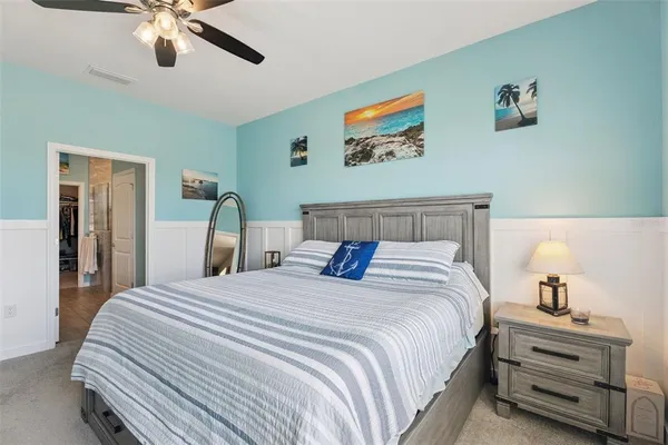 a bedroom with bed and a chandelier