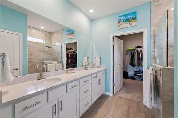 a spacious bathroom with a double vanity sink and a large mirror