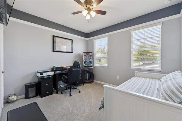 a view of a workspace with furniture and a window