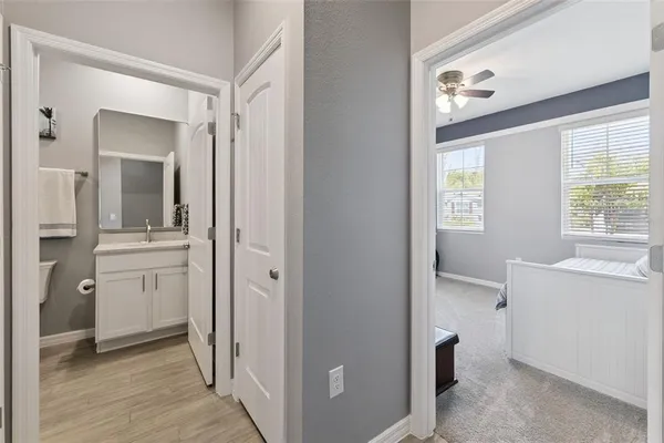 a view of a bathroom with a sink mirror and window