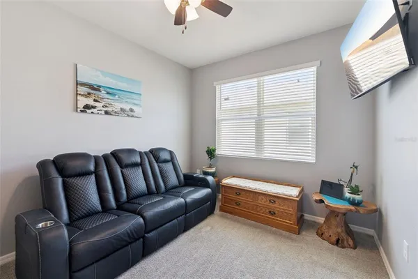 a bedroom with a couch and a window