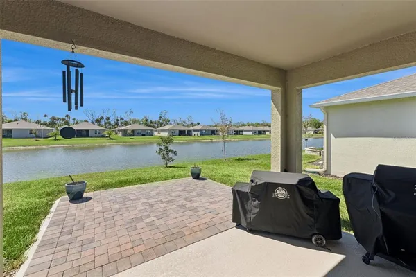 a living room with furniture floor to ceiling window and a yard