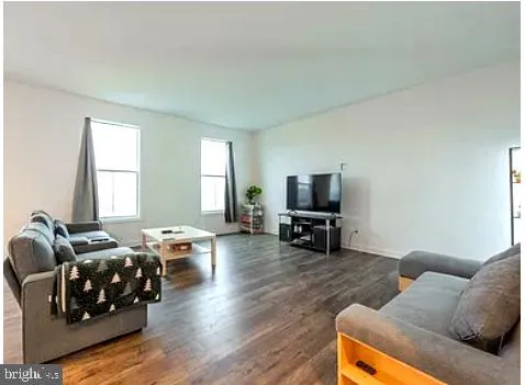 a view of a kitchen with a refrigerator and window