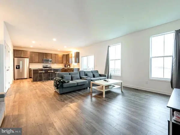 a view of living room with furniture and wooden floor