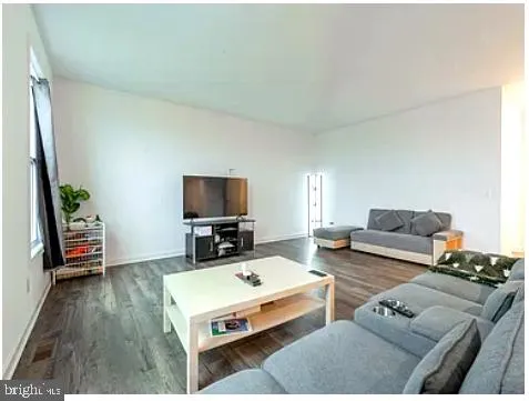 a spacious bedroom with a bed and a couch