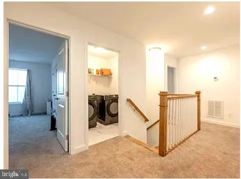 a bathroom with a double vanity sink toilet and a mirror