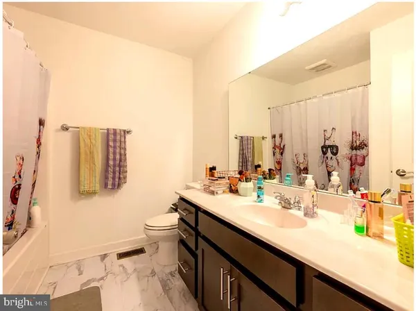 a view of a balcony with a small white wooden fence