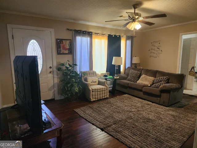 a living room with furniture and a chandelier