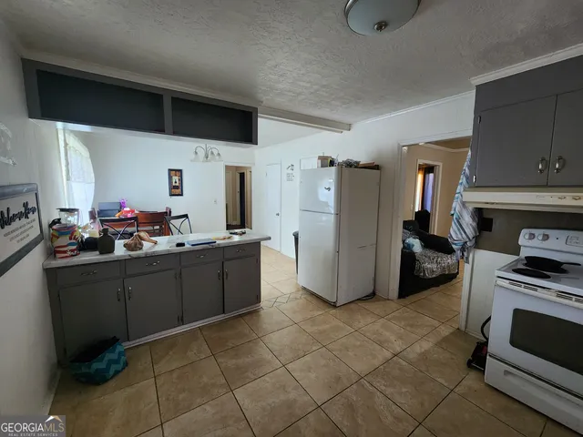 a kitchen with refrigerator and cabinets