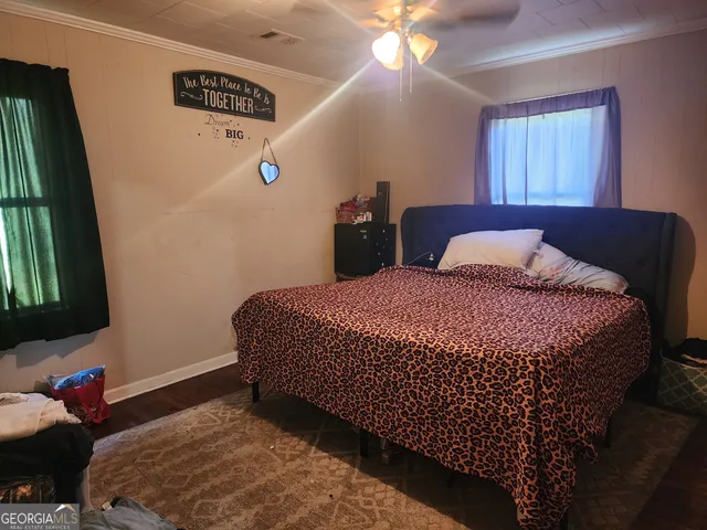 a bedroom with bed and window