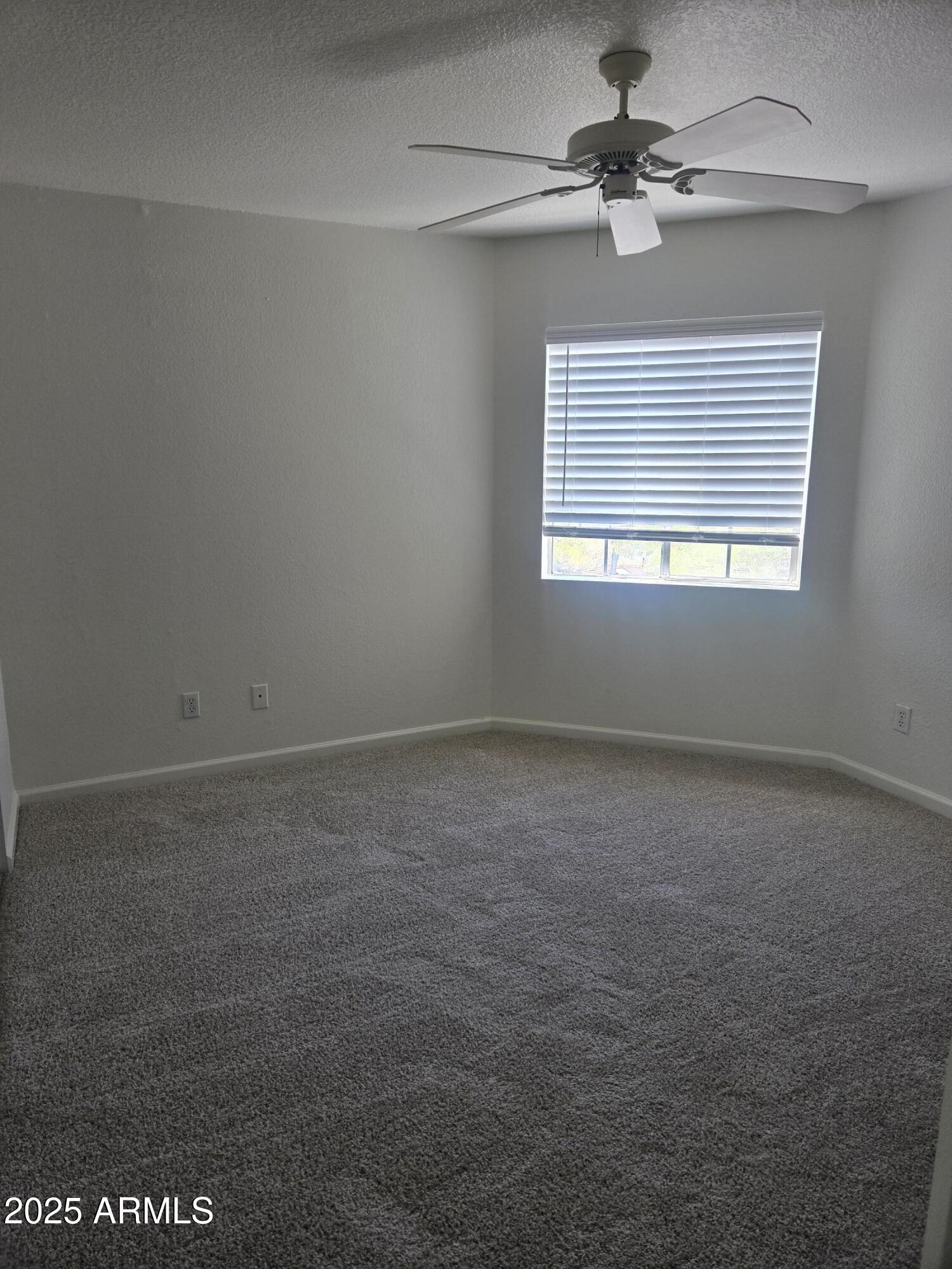 1720 East Thunderbird Road, Unit 2094 Phoenix, AZ 85022 - Photo 19 of 36 an empty room with a window and a fan