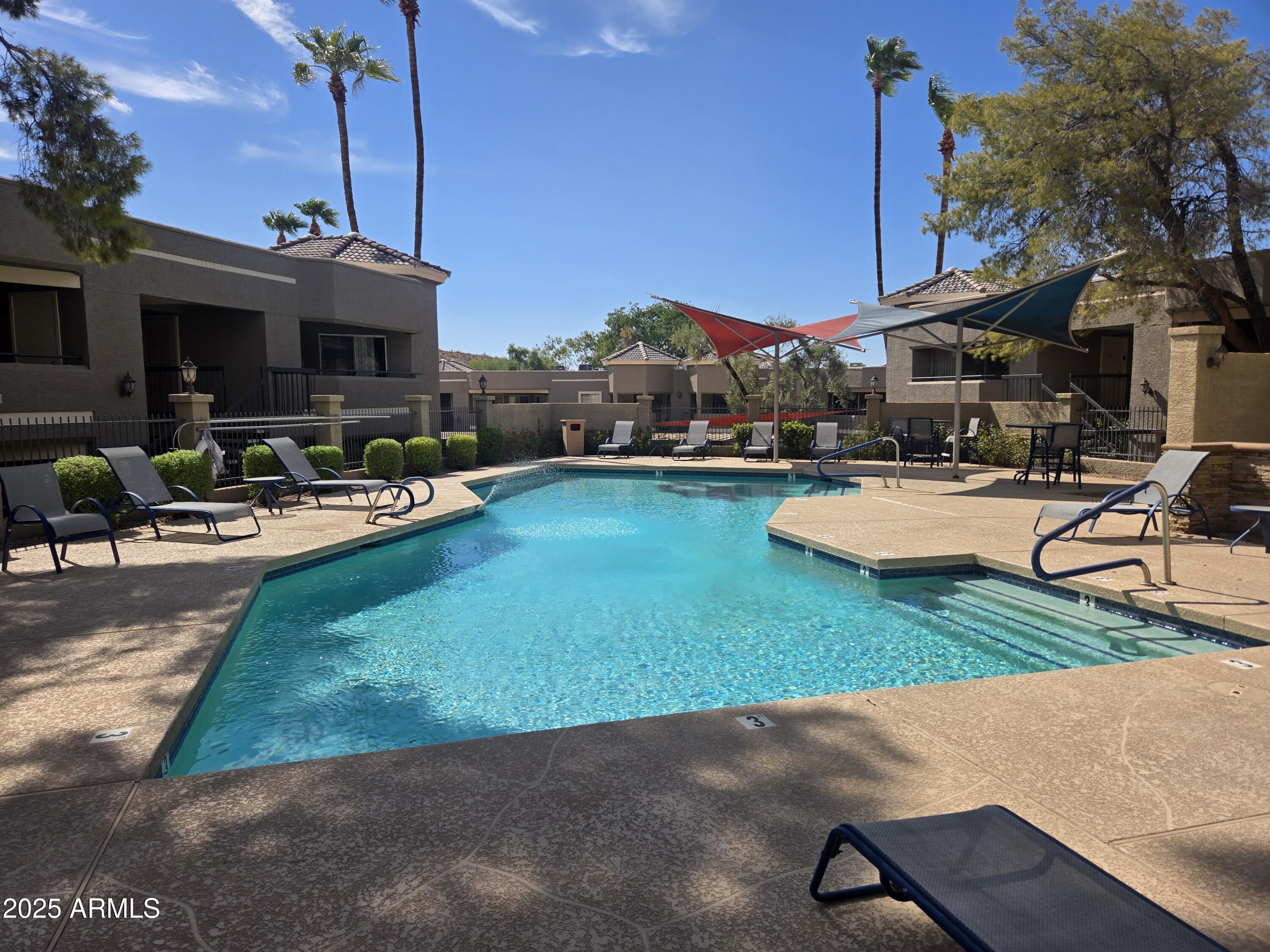 1720 East Thunderbird Road, Unit 2094 Phoenix, AZ 85022 - Photo 27 of 36 a front view of a house with swimming pool garden and patio