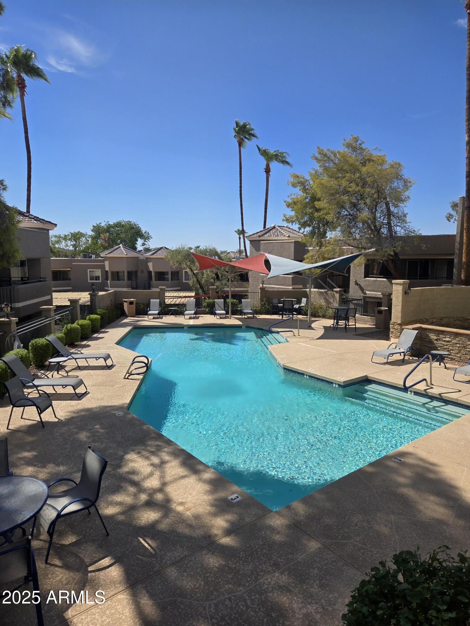 1720 East Thunderbird Road, Unit 2094 Phoenix, AZ 85022 - Photo 28 of 36 a view of a patio with table and chairs a barbeque