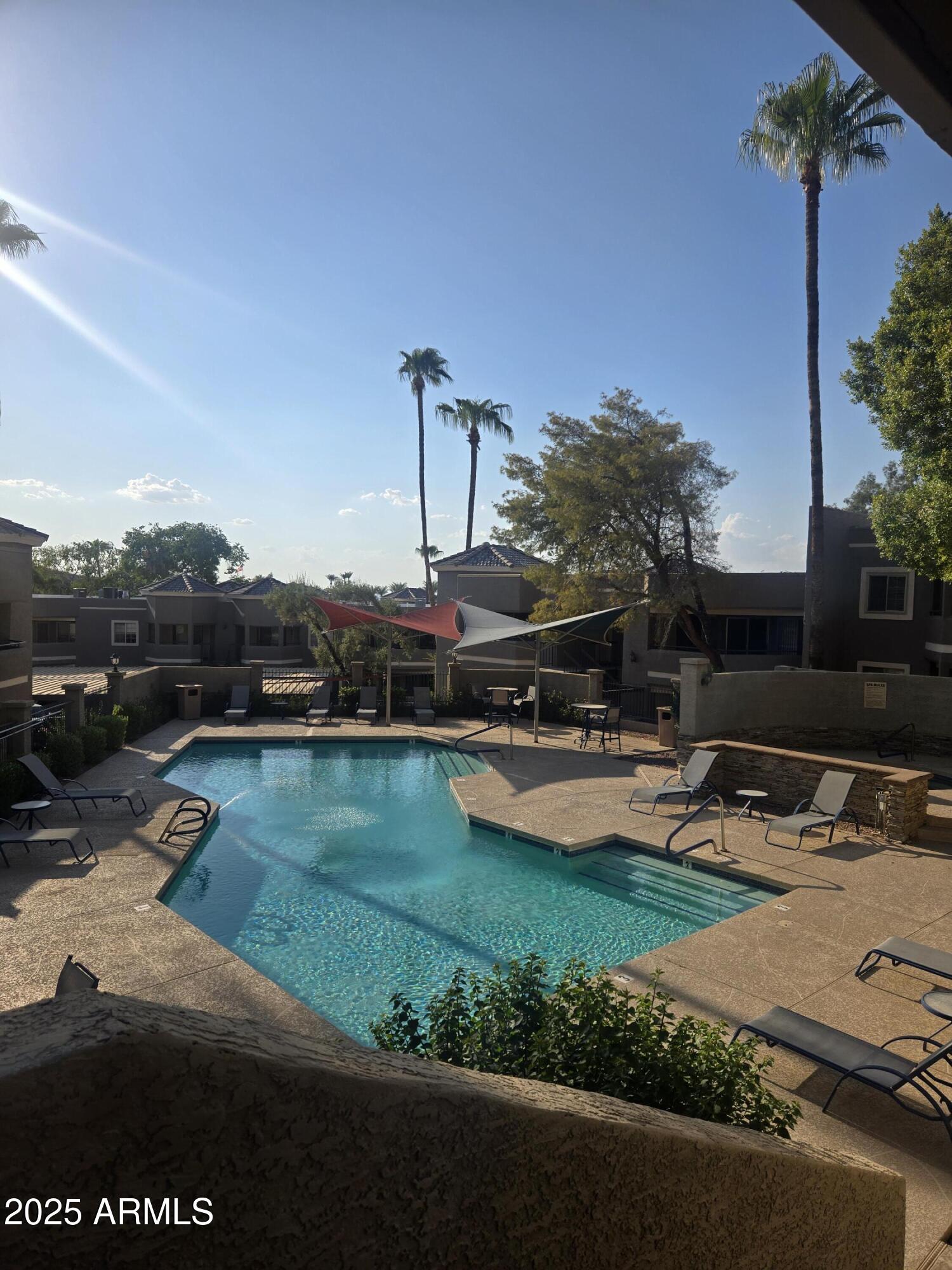 1720 East Thunderbird Road, Unit 2094 Phoenix, AZ 85022 - Photo 29 of 36 a view of a lake with lawn chairs and large trees